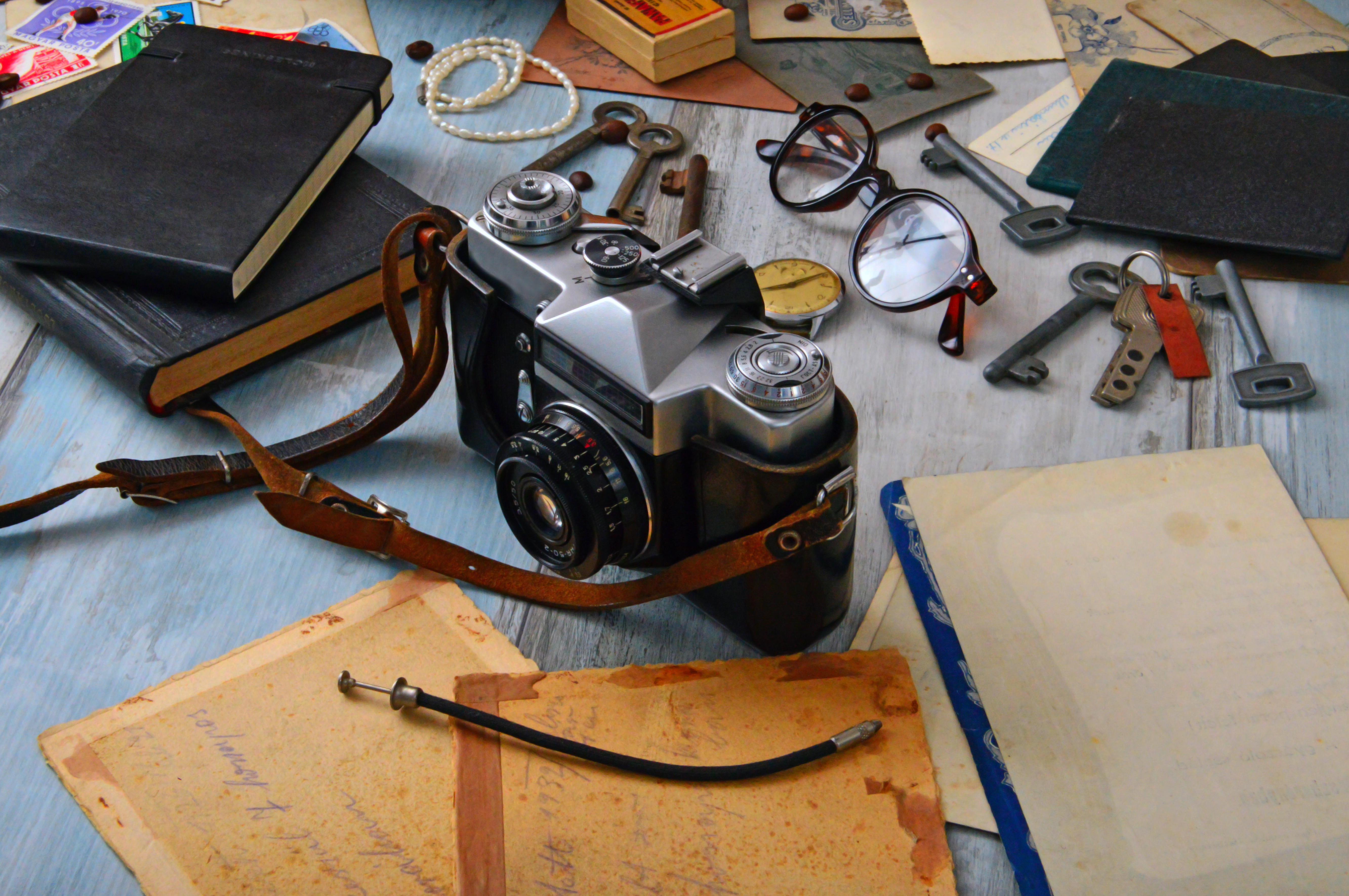 black-and-gray-camera-on-table-surrounded-by-books-1416860